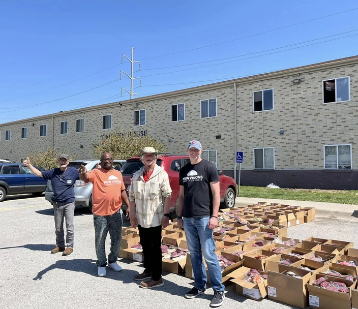 People in front of boxes filled with donations