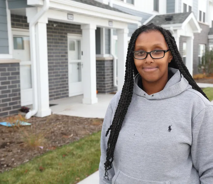 woman standing in front of townhomes