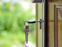 A key in a lock on a wooden door