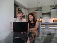 Couple at table looking at compute