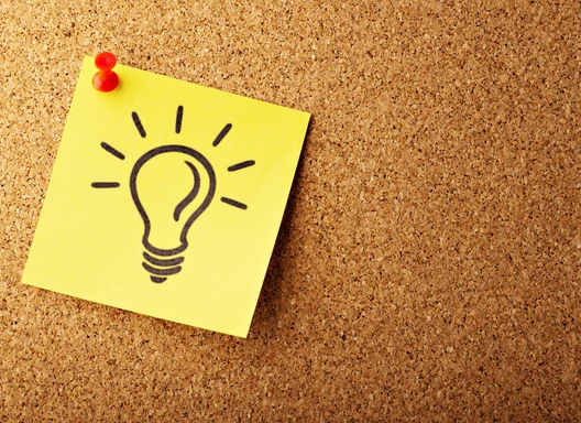 yellow post it note with a drawing of a light bulb