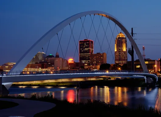 bridge in front of des moines skyline at night