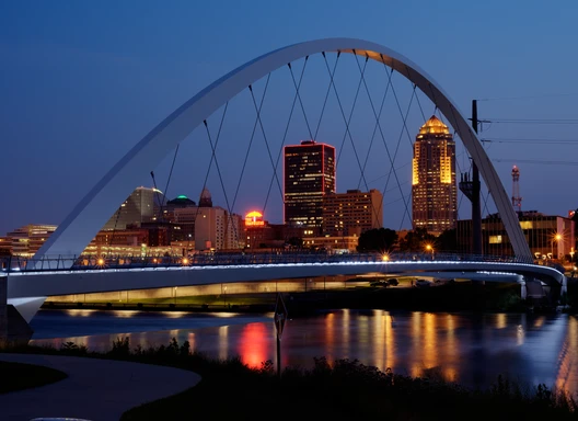 bridge in front of des moines skyline at night