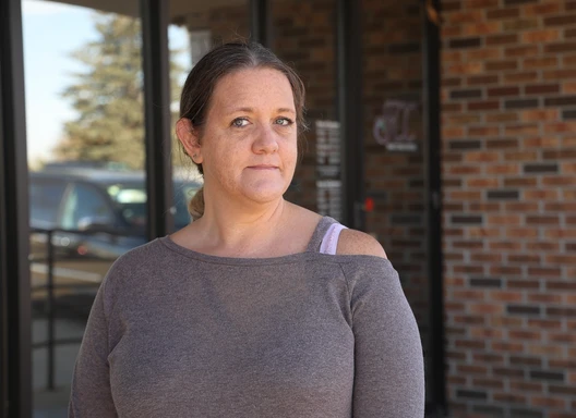 A woman standing outside of a crisis center