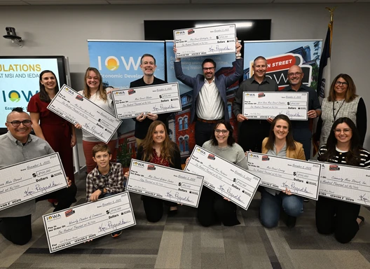 award recipients holding giant checks