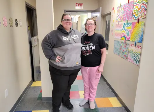 Two women standing side by side.