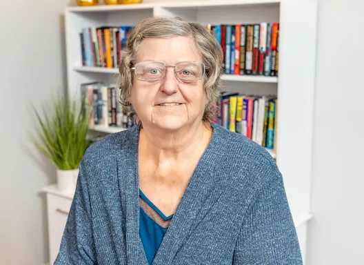 Woman in cardigan, headshot photo.