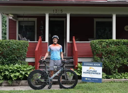 man on bike in front of house