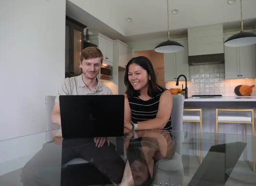 Couple at table looking at compute