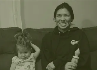 A woman sitting on a couch with a small child