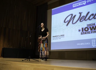Student competing in the 2024 Iowa State Finals of Poetry Out Loud