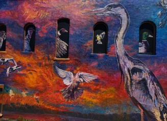 Mural of birds against a brightly colored background