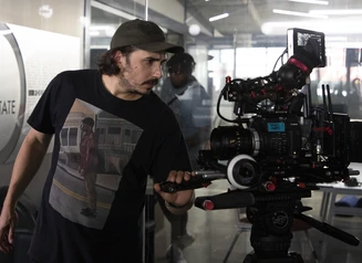 Closeup view of a camera operator and other crew members