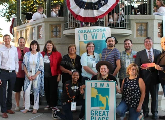 People holding an Iowa Great Place sign