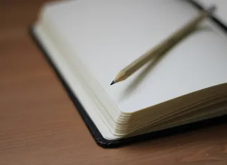 Close up of book and pencil