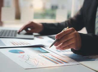 Person reviewing charts and graphs