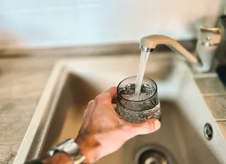 Filling glass with tap water
