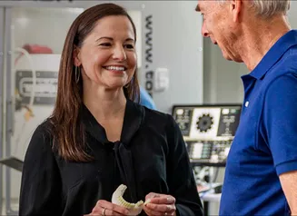 Two people standing in a laboratory space