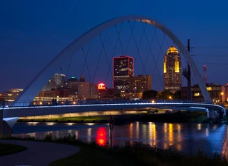 Downtown skyline at night with a bridge
