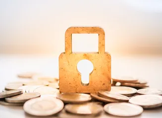 Coins surrounding a highlighted lock and keyhole 
