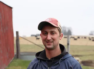 farmer standing near a barn
