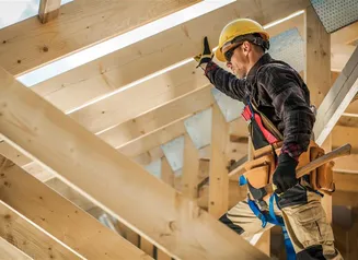 Construction Worker with toolbelt working