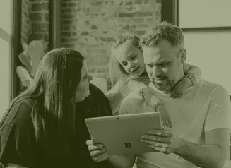 Mom, dad, and daughter looking at laptop