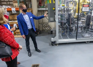 Man wearing mask showing off technology at Intellisee