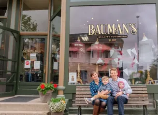 Portrait of the entire Randall family in front of the Bauman's building on the left