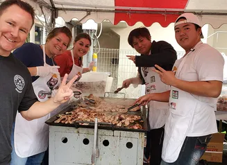 Nick Jones, CEO of Berkwood Farms with Japanese partners next to a grill