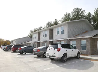 Townhome style housing with cars parked in front