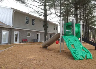 Playground equipment behind buildings