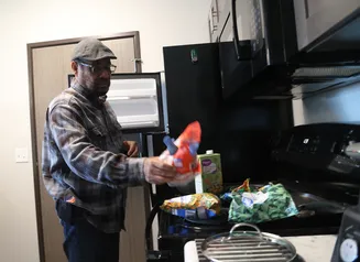 A man in a hat cooking a meal
