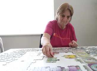A woman working on a jigsaw puzzle