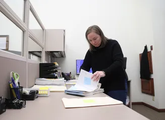 Woman going through real estate documents at a desk