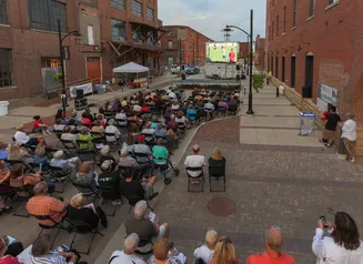 People sitting outdoors watching a movie