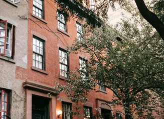Exterior of an apartment building with a tree