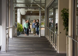 people walking down a hallway in an office building