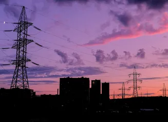 silhouette of buildings under cloudy sky during sunset