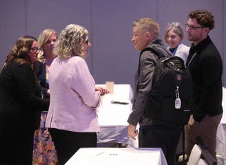 group of 6 people standing and talking