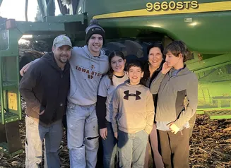Family in front of tractor.