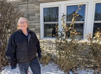 Woman standing in front of newly installed windows.