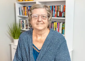 Woman in cardigan, headshot photo.