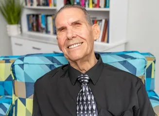 Headshot of man in dress shirt and tie.