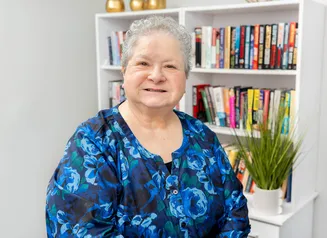 Woman's headshot in floral shirt