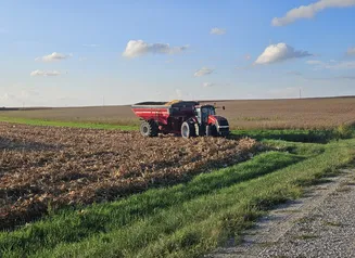 Red tractor on farm field.