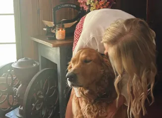 girl with dog inside home