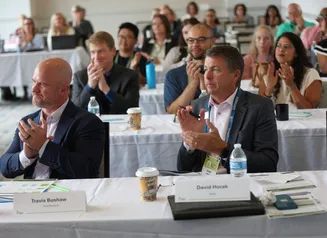 Judges and audience clapping after pitch competition