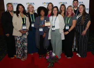 New Visions team posing with an award