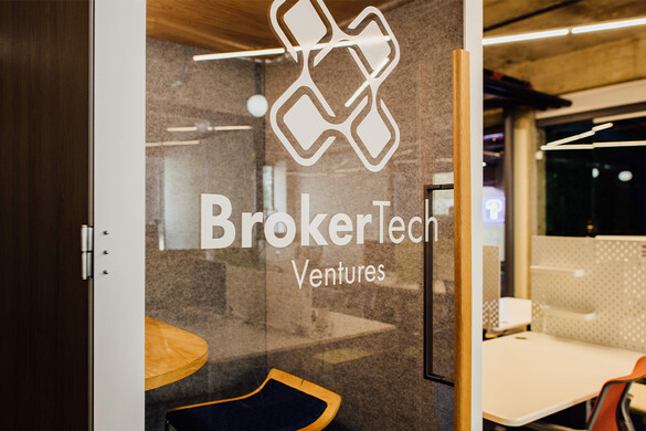 photo of a glass door of a soundbooth office with a logo for BrokerTech Ventures